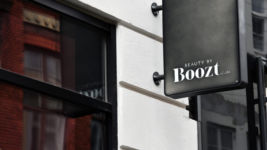 Skilt for Beauty by Boozt.com på en hvit bygning i København.